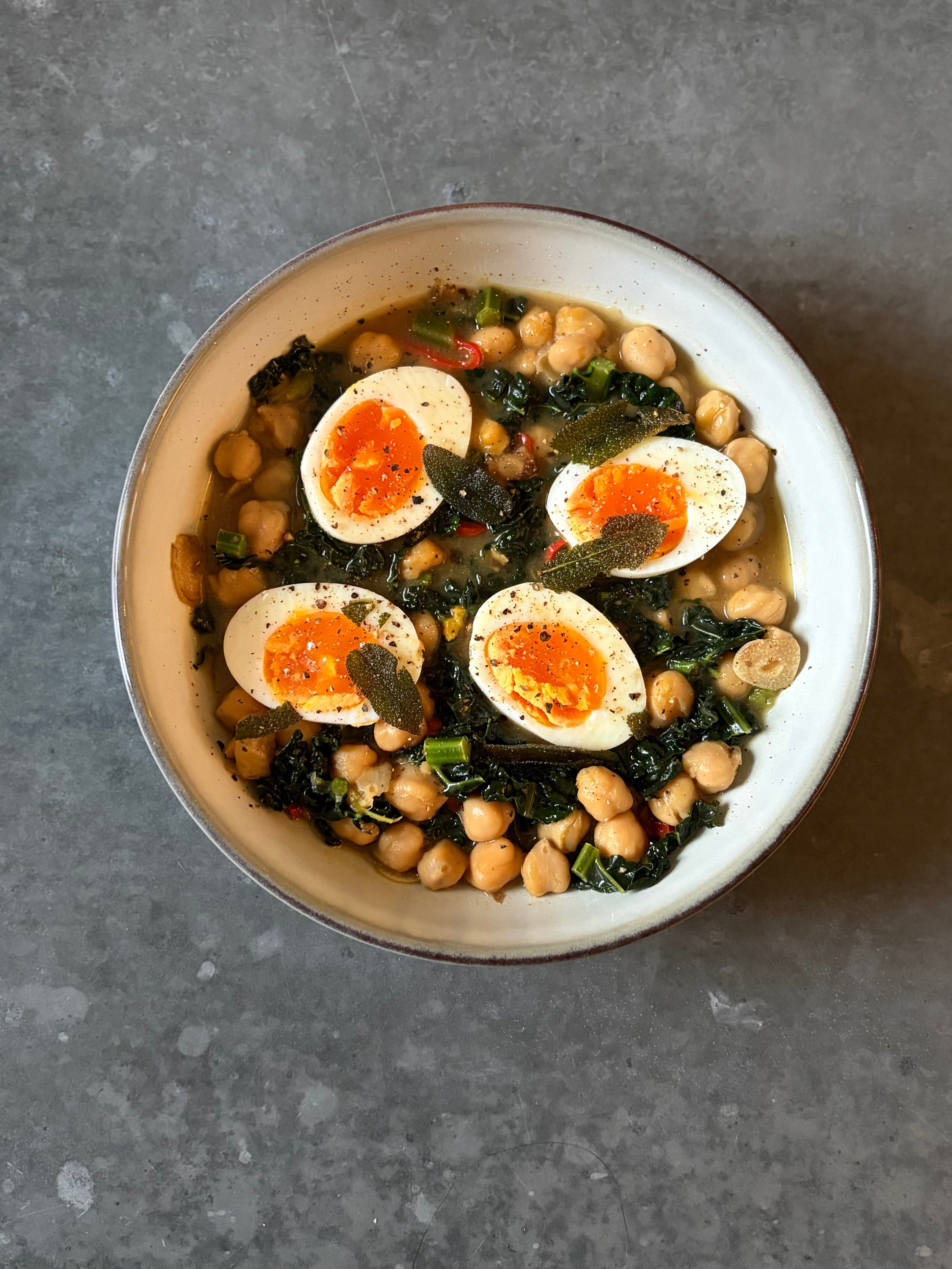 High protein miso chickpeas with jammy eggs and crispy sage in a bowl, healthy high fibre meal