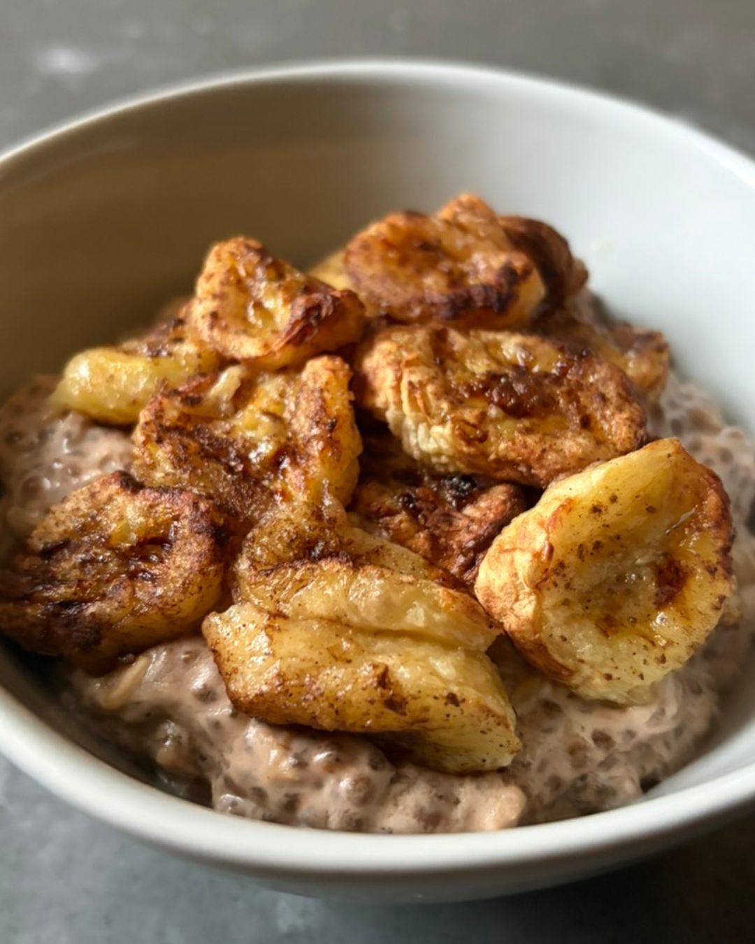 High protein banana chia porridge topped with roasted cinnamon banana. A high fibre, balanced breakfast that’s simple to make and naturally filling.